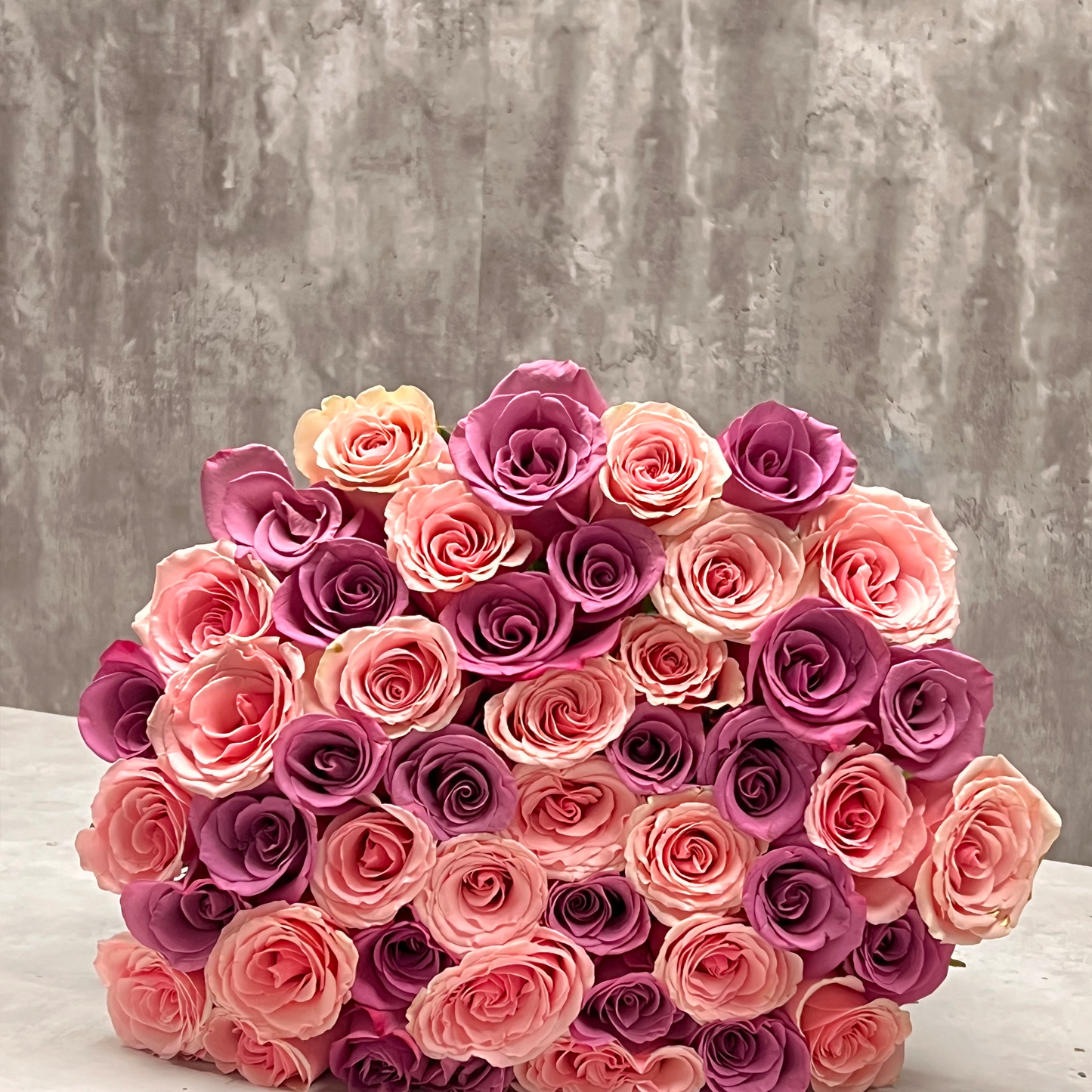 A captivating bouquet featuring blush pink and purple long-stem roses, symbolizing grace and enchantment. From our Valentine's Day Collection, available for same-day delivery in Miami, FL. Elevate your celebration with this unique blend of colors. Order now for a moment of pure romance and sophistication.