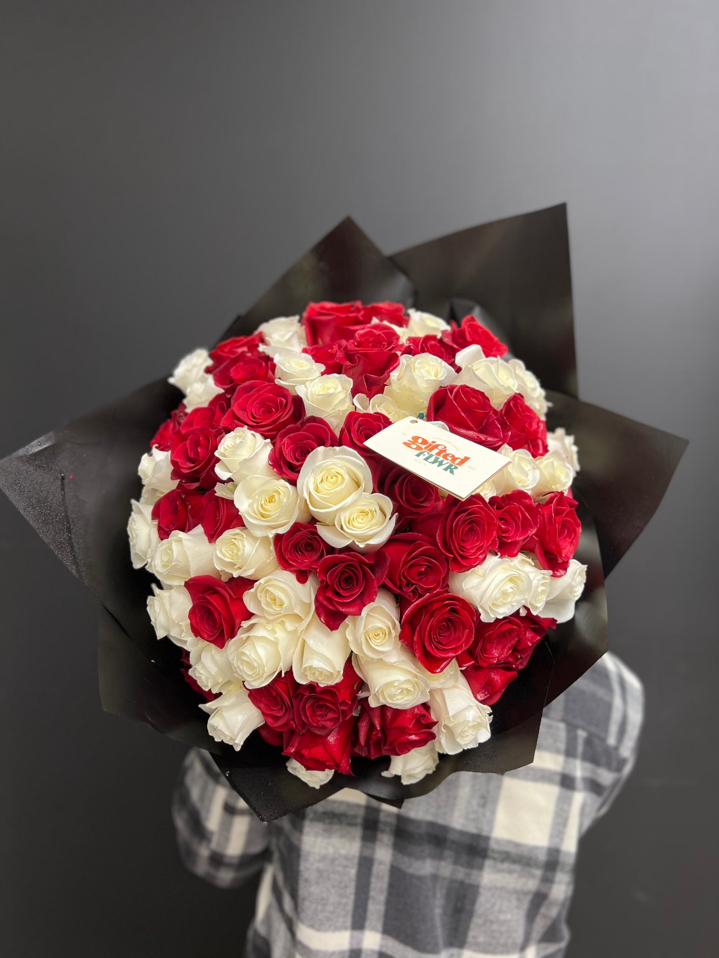 A striking combination of red and white long-stem roses, expressing love and purity. Perfect for any special occasion, this bouquet embodies elegance and timeless beauty. Available for same-day delivery in Miami, FL.